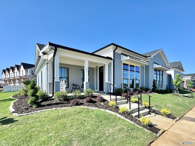 view of front of property with a front yard and covered porch