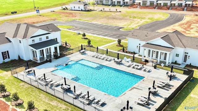 view of pool with a patio area, french doors, and a yard