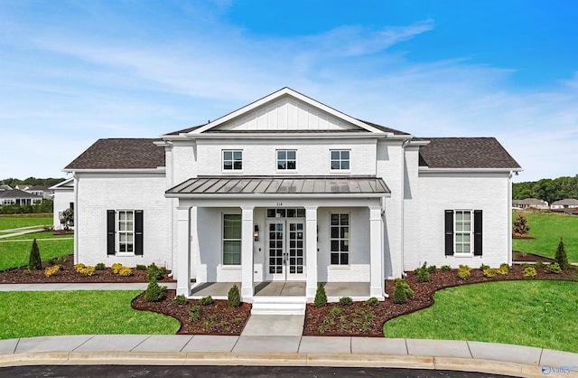 modern farmhouse style home with a porch and a front yard