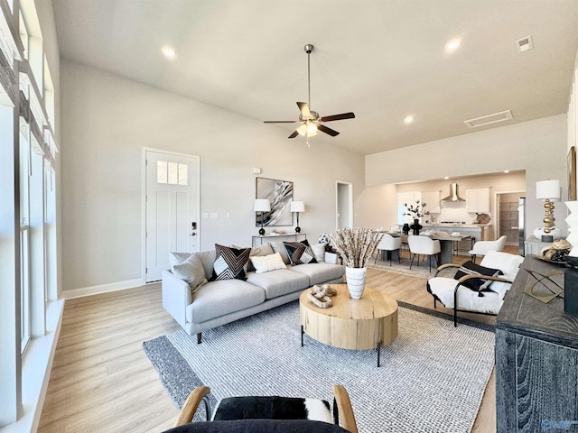 living room featuring ceiling fan and light hardwood / wood-style floors