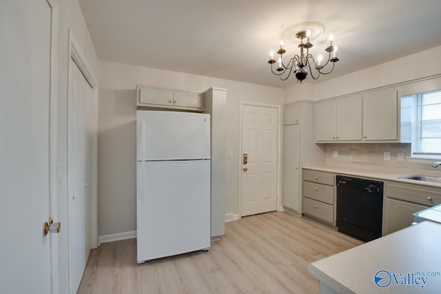 8201 Willowbrook Cir Unit B, Huntsville, AL 35802 - kitchen with dishwasher, freestanding refrigerator, light wood finished floors, a chandelier, and light countertops