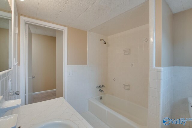 8201 Willowbrook Cir Unit B, Huntsville, AL 35802 - bathroom featuring tile walls, shower / washtub combination, toilet, wainscoting, and double vanity