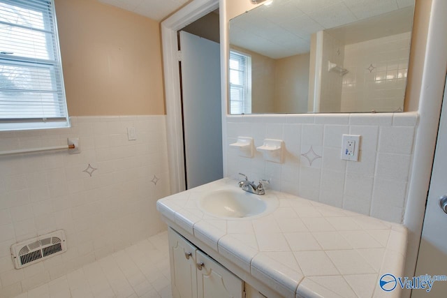 8201 Willowbrook Cir Unit B, Huntsville, AL 35802 - full bath with tile walls, vanity, a tile shower, a wainscoted wall, and tile patterned flooring