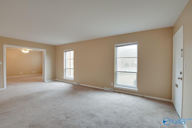 8201 Willowbrook Cir Unit B, Huntsville, AL 35802 - empty room featuring light colored carpet, baseboards, and ceiling fan
