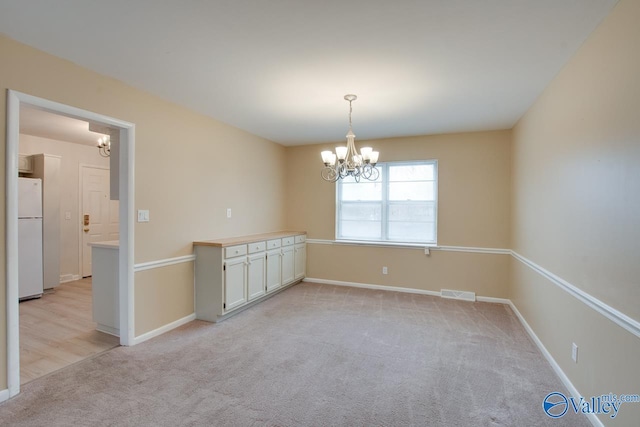 8201 Willowbrook Cir Unit B, Huntsville, AL 35802 - unfurnished room with a chandelier, light colored carpet, and baseboards