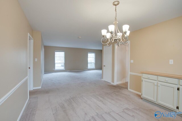 8201 Willowbrook Cir Unit B, Huntsville, AL 35802 - spare room featuring a chandelier, light colored carpet, and baseboards