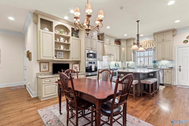 dining room featuring baseboards, ornamental molding, light wood-type flooring, built in desk, and recessed lighting