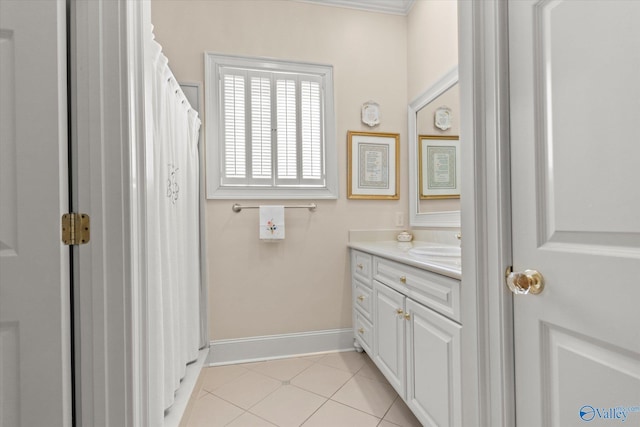 bathroom featuring tile patterned floors, baseboards, and vanity