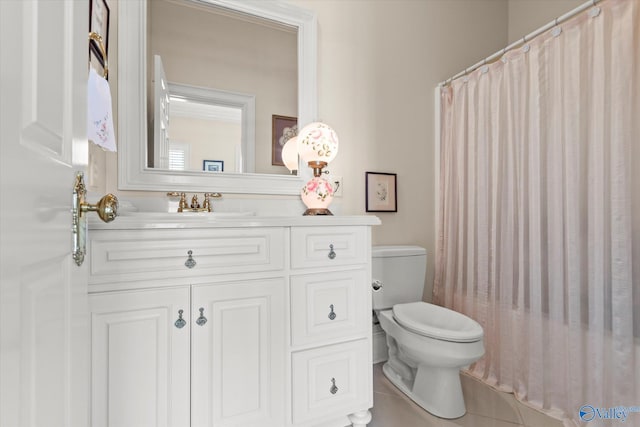 bathroom featuring toilet, vanity, a shower with shower curtain, and tile patterned floors