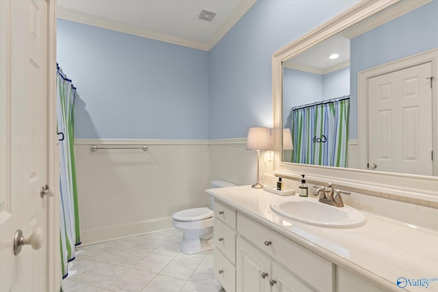 full bath with toilet, a wainscoted wall, tile patterned floors, crown molding, and vanity