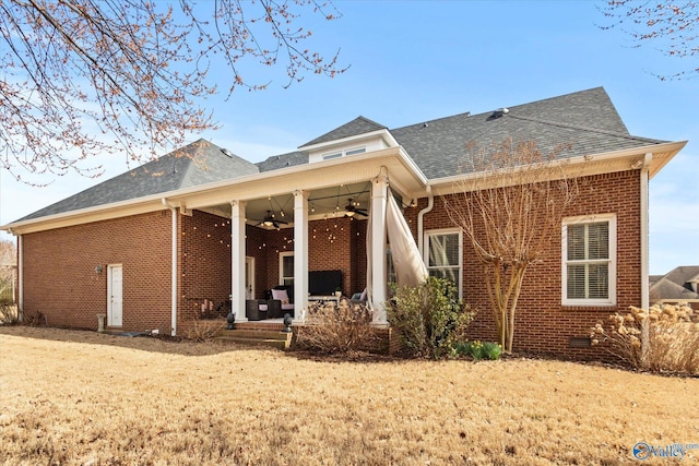 back of property featuring roof with shingles, brick siding, crawl space, and a ceiling fan