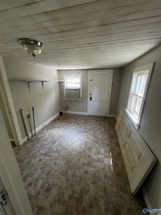 interior space featuring brick patterned floor, wooden ceiling, and cooling unit
