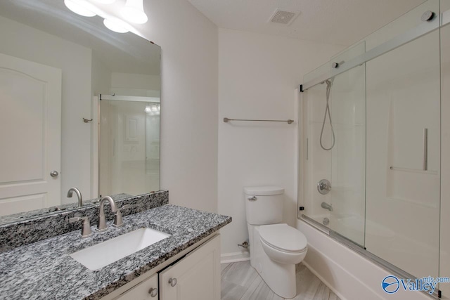 bathroom featuring toilet, shower / bath combination with glass door, visible vents, and vanity