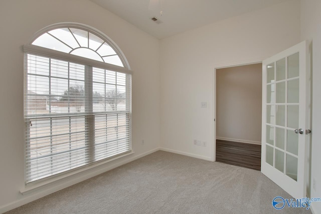 carpeted spare room with visible vents