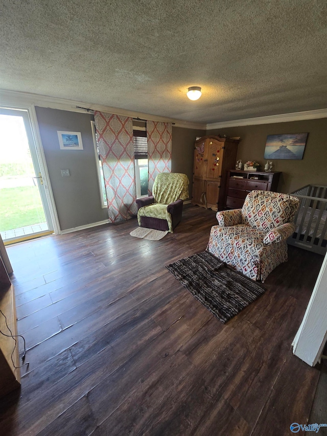 living room featuring crown molding, dark hardwood / wood-style flooring, and a textured ceiling