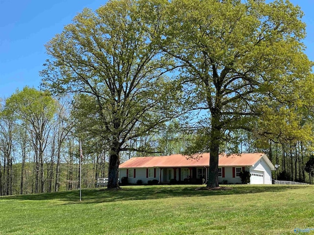 ranch-style home featuring an attached garage and a front yard