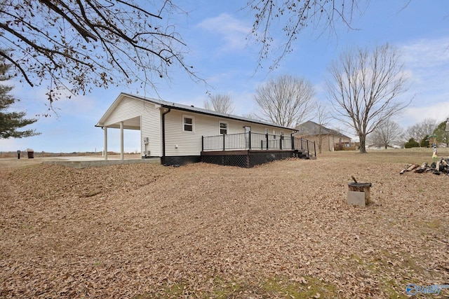 rear view of house with a wooden deck