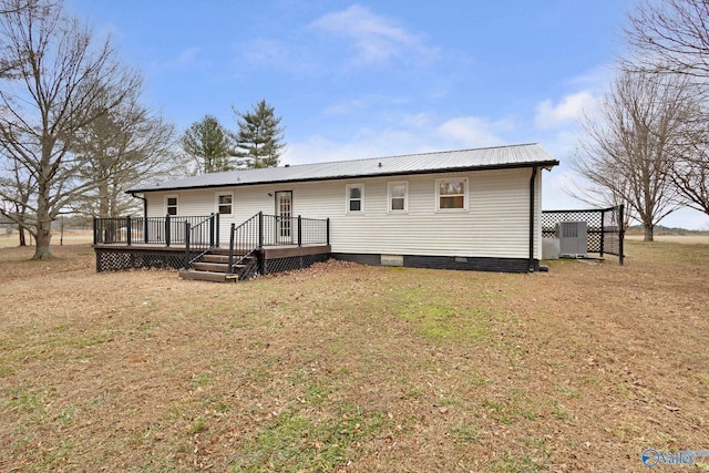 rear view of house with a wooden deck, central AC, and a lawn