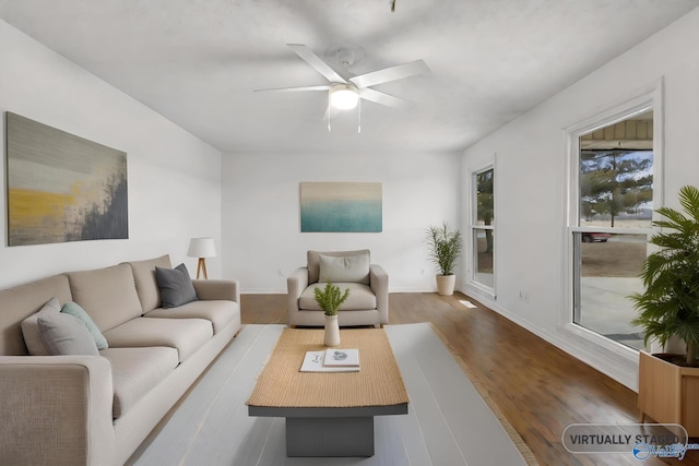 living room with dark hardwood / wood-style floors and ceiling fan