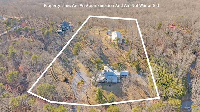 birds eye view of property featuring a wooded view