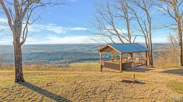 view of yard featuring a gazebo and a forest view