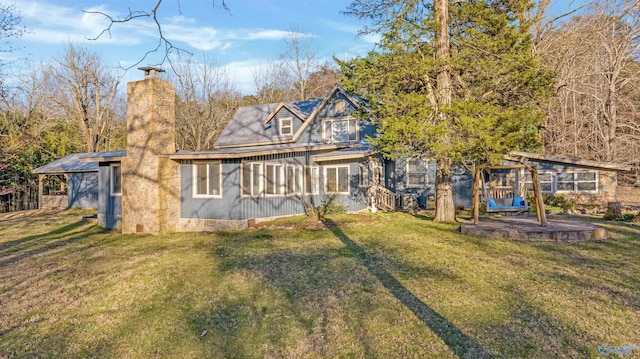 view of front of property with a chimney and a front lawn