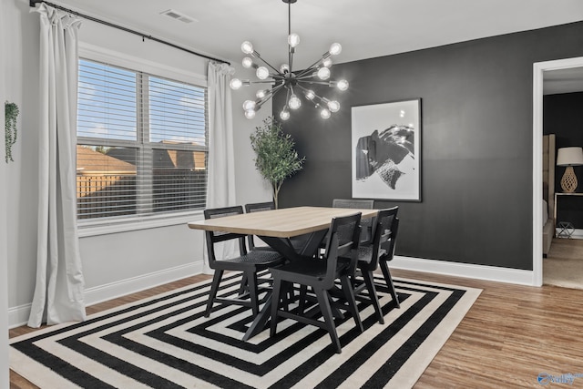 132 Fall Meadow Dr, Harvest, AL 35749 - dining area with a chandelier, wood finished floors, and baseboards