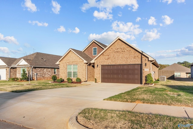 132 Fall Meadow Dr, Harvest, AL 35749 - view of front of house featuring an attached garage, concrete driveway, brick siding, and a front lawn
