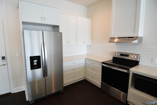 kitchen with appliances with stainless steel finishes, decorative backsplash, white cabinetry, and under cabinet range hood