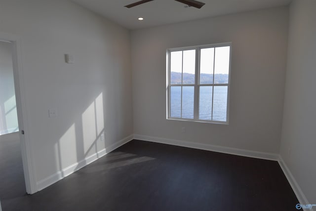 unfurnished room featuring baseboards, a ceiling fan, recessed lighting, and dark wood-style floors