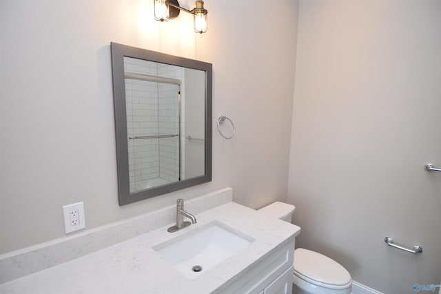 full bathroom featuring vanity, an enclosed shower, and toilet