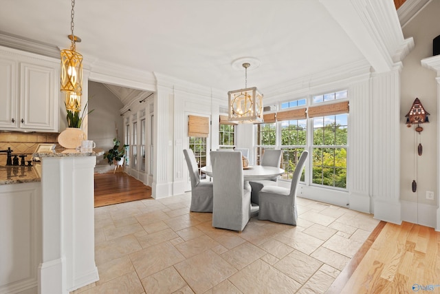 unfurnished dining area featuring crown molding and a chandelier