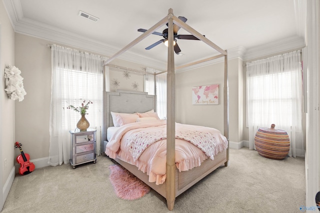 carpeted bedroom featuring multiple windows, ornamental molding, and ceiling fan