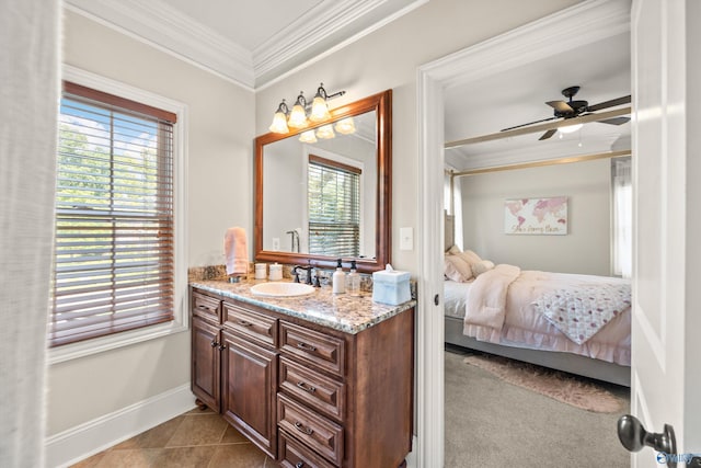 bathroom with tile patterned flooring, crown molding, vanity, and ceiling fan