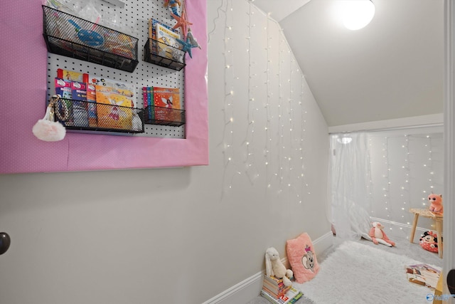 playroom with vaulted ceiling and carpet flooring