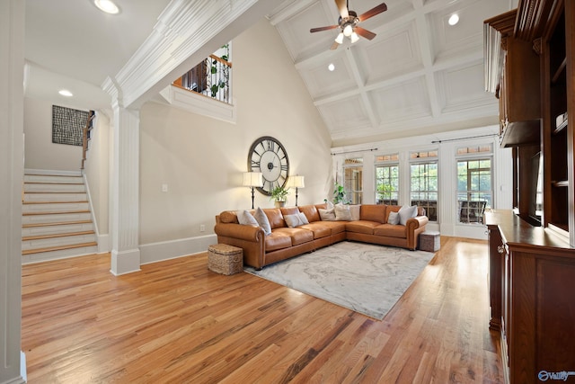 living room with ornate columns, crown molding, high vaulted ceiling, light wood-type flooring, and ceiling fan