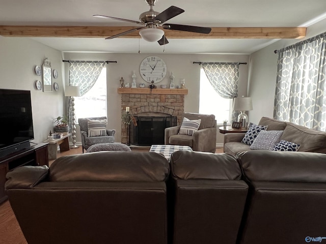 living room featuring a fireplace, beamed ceiling, baseboards, and ceiling fan