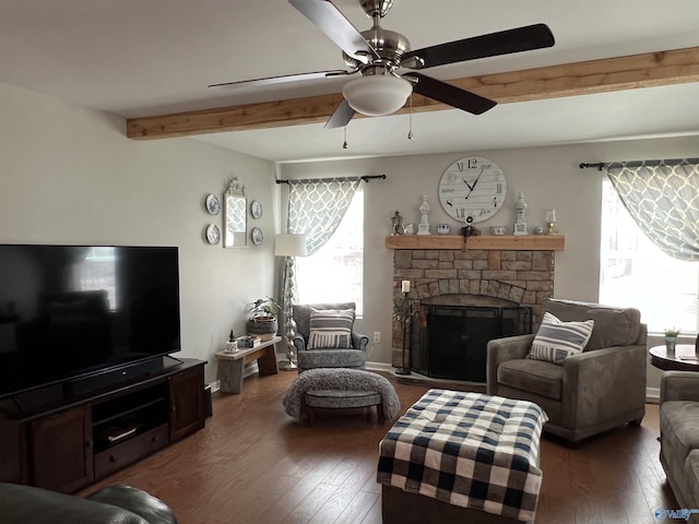 living area with ceiling fan, hardwood / wood-style flooring, a fireplace, baseboards, and beam ceiling