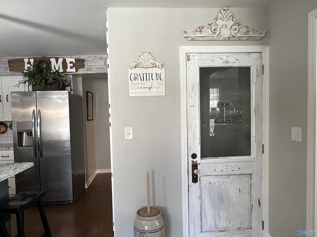 interior space with white cabinetry, decorative backsplash, dark wood-type flooring, and stainless steel fridge with ice dispenser