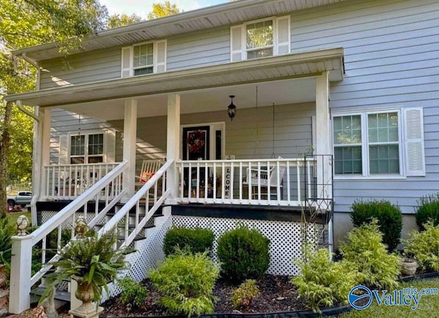 view of front of house featuring stairway and a porch