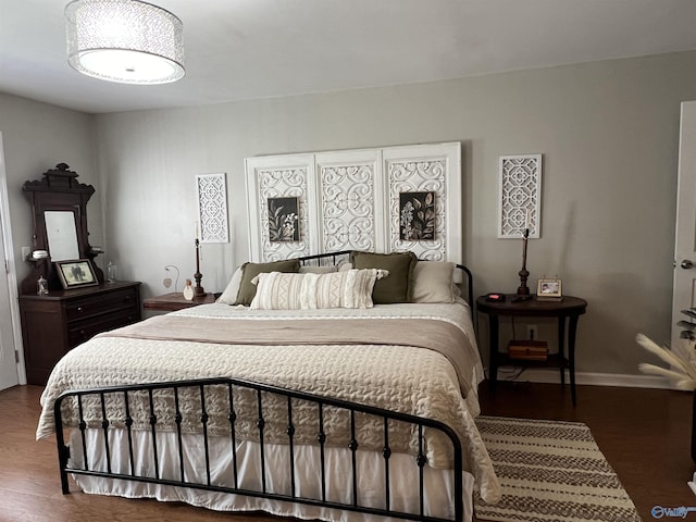 bedroom featuring wood finished floors and baseboards