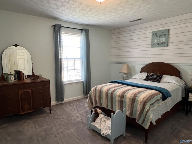 carpeted bedroom featuring visible vents, a textured ceiling, and baseboards