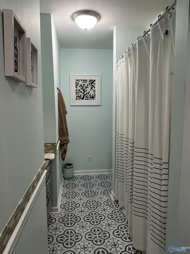 bathroom featuring tile patterned flooring and baseboards