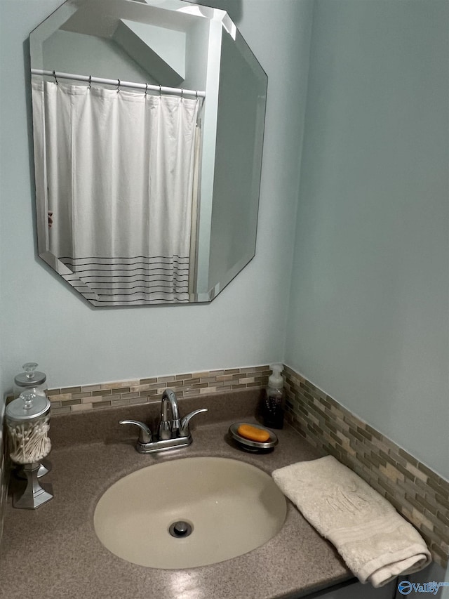 full bathroom featuring tasteful backsplash and vanity