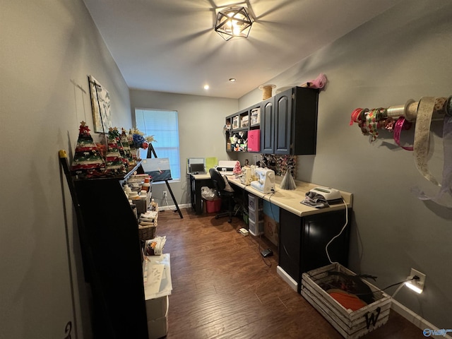 interior space featuring dark wood-style flooring, light countertops, and baseboards