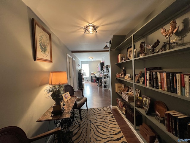 hallway with dark wood-type flooring and baseboards