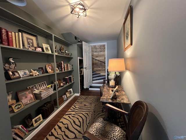 living area with stairs and dark wood finished floors