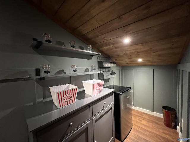 interior space with wooden ceiling, recessed lighting, a decorative wall, vaulted ceiling, and light wood-type flooring