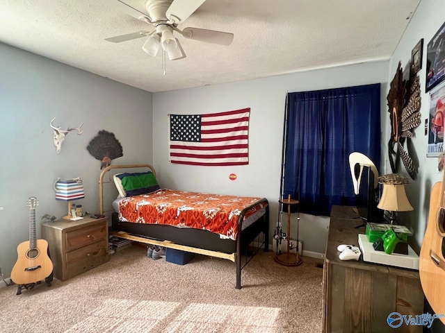 bedroom with ceiling fan, carpet floors, and a textured ceiling