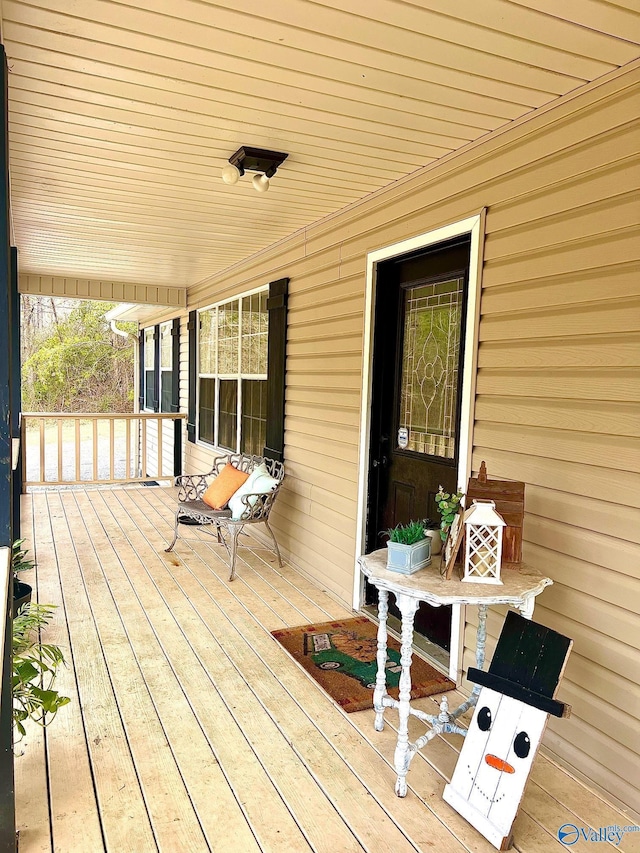 wooden terrace featuring covered porch